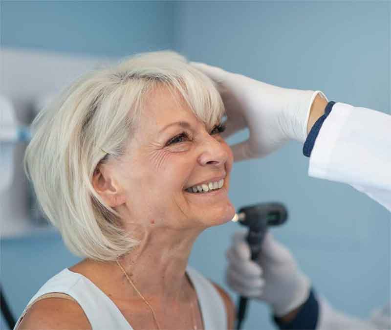 Woman getting ear examined